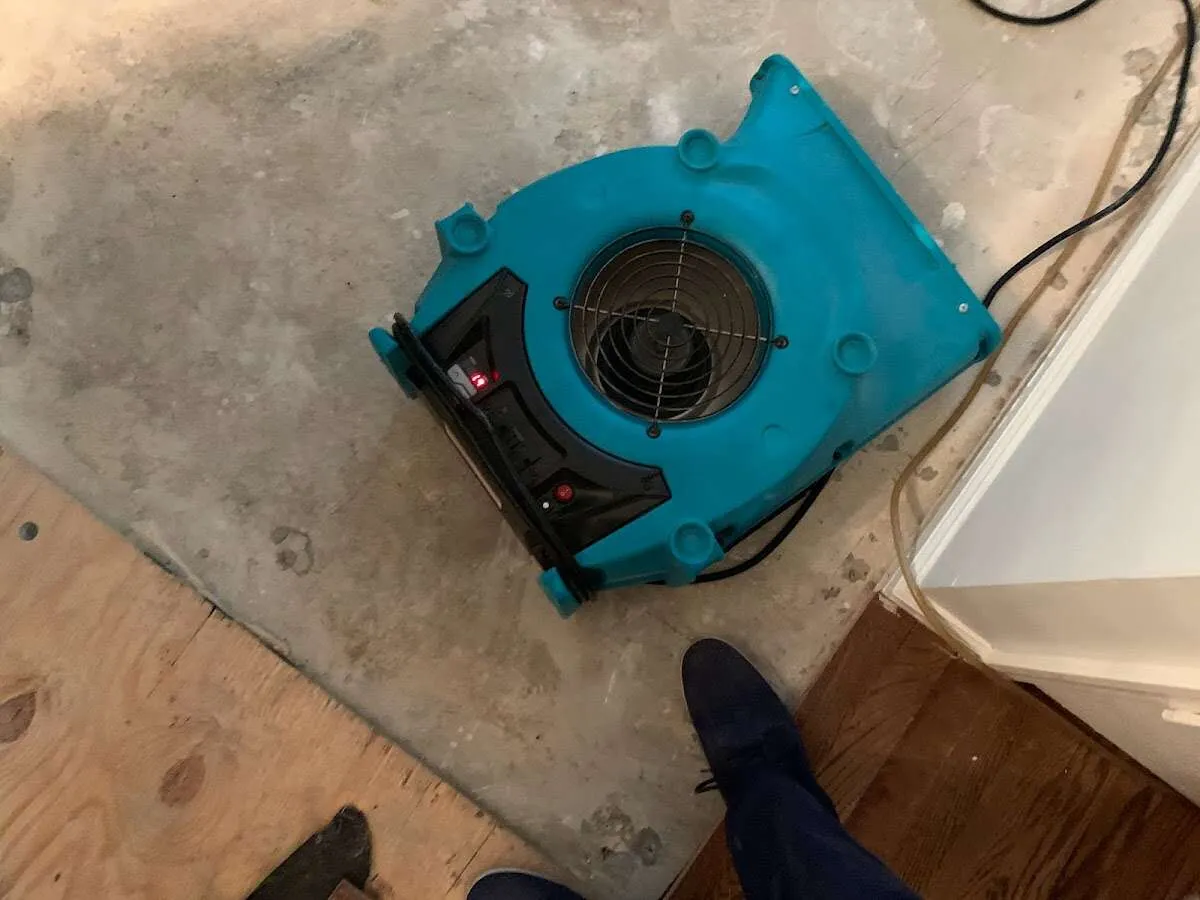 Air mover drying subfloor during Leak Detection & Repair in Eliot